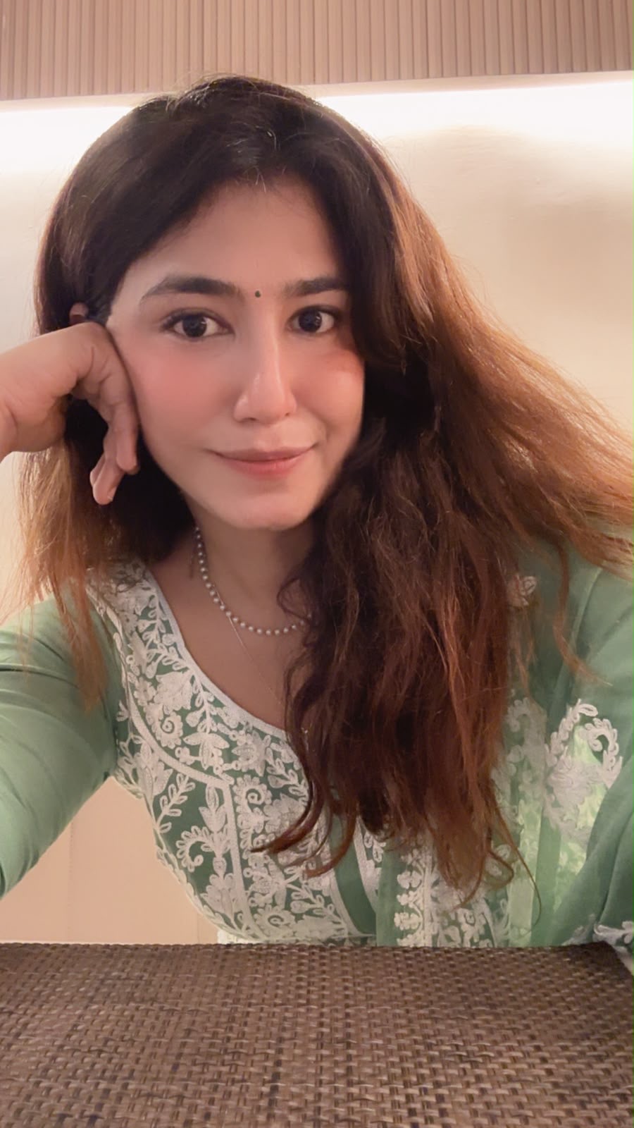 Portrait of Tara in a soft green embroidered outfit