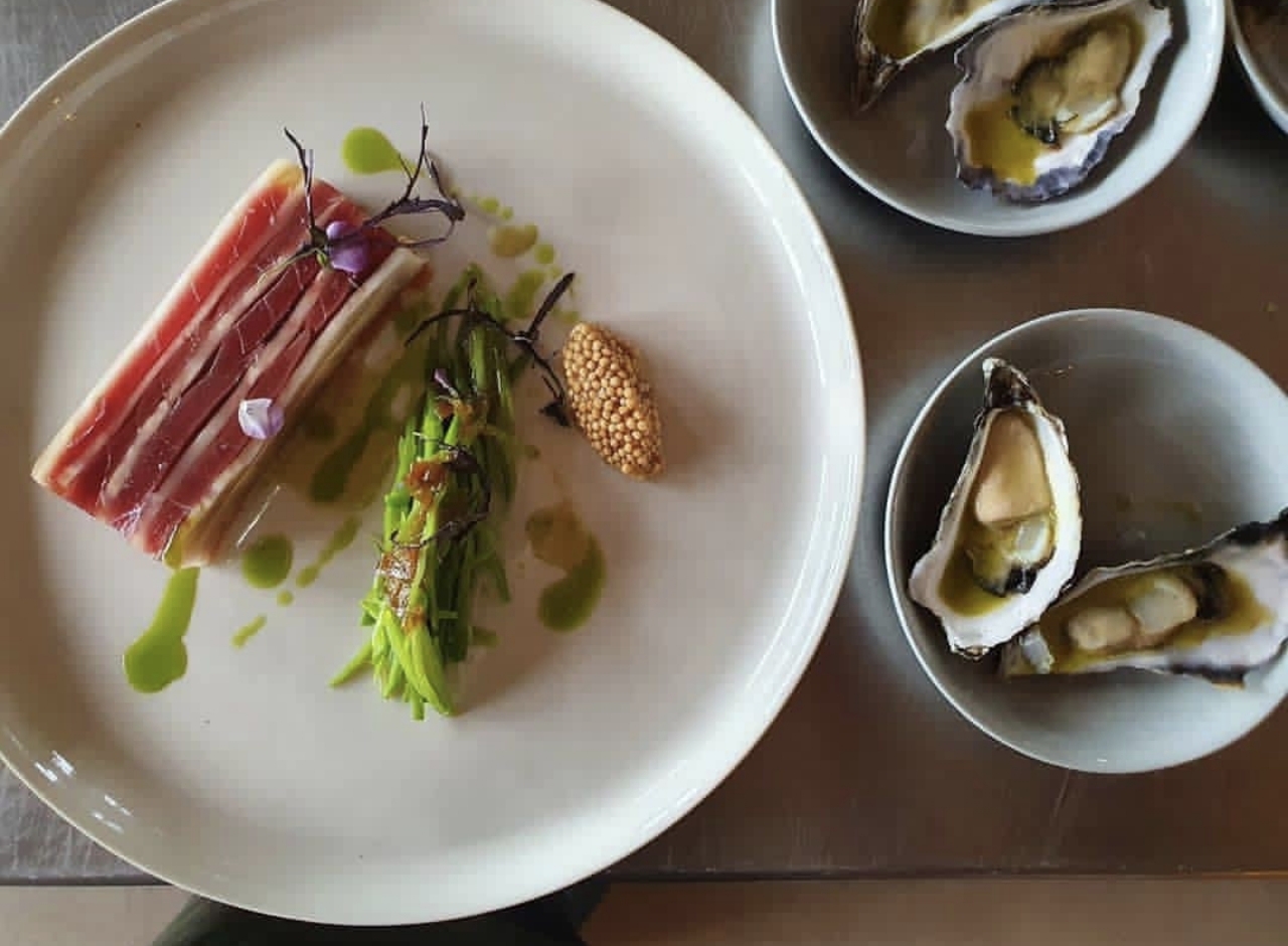 Cured fish and grilled greens served with oysters